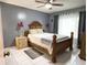 Comfortable main bedroom with a wooden bed frame, tiled floor, and gray walls at 5815 England Ave, Orlando, FL 32808