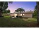 Spacious backyard with a covered patio perfect for outdoor entertaining and relaxation at 5820 Indian Hill Rd, Orlando, FL 32808
