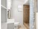 Bright bathroom with a white sink and toilet, and a tiled shower with a shower curtain at 5820 Indian Hill Rd, Orlando, FL 32808
