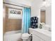 Bathroom featuring a bathtub, shower, toilet, and sink with a light blue shower curtain at 5820 Indian Hill Rd, Orlando, FL 32808