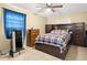 Comfortable bedroom featuring a ceiling fan, tile flooring and a beautiful, patterned bedspread at 5820 Indian Hill Rd, Orlando, FL 32808