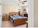 Relaxing bedroom featuring wooden furniture and a ceiling fan with neutral paint colors at 5820 Indian Hill Rd, Orlando, FL 32808