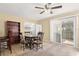 Cozy dining area with a round table, four chairs, and sliding glass doors to the backyard at 5820 Indian Hill Rd, Orlando, FL 32808
