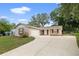 Charming single-story home featuring a well-manicured front yard and attached garage, perfect for suburban living at 5820 Indian Hill Rd, Orlando, FL 32808