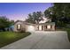 Charming single-story home featuring a well-manicured front yard and attached garage, perfect for suburban living at 5820 Indian Hill Rd, Orlando, FL 32808