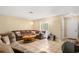 Bright living room with a large sectional sofa, tile flooring, and sliding glass doors to the backyard at 5820 Indian Hill Rd, Orlando, FL 32808