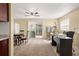 Cozy living room featuring a ceiling fan, desk, and sliding glass doors leading to the backyard at 5820 Indian Hill Rd, Orlando, FL 32808