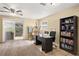 Versatile office space with a ceiling fan, desk, bookshelf, and sliding glass doors to the backyard at 5820 Indian Hill Rd, Orlando, FL 32808