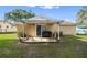 Charming covered patio featuring a grill and chairs for enjoying outdoor living at 5820 Indian Hill Rd, Orlando, FL 32808