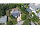 Aerial view of the property, showcasing its layout, a pool, and surrounding landscaping among mature trees at 60 Palmetto Dr, Ormond Beach, FL 32176