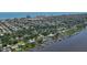 Expansive aerial view shows the property's location near waterfront homes with docks and ocean in the distance at 60 Palmetto Dr, Ormond Beach, FL 32176