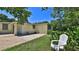 Charming backyard with a white chair and lush greenery, perfect for enjoying outdoor relaxation at 60 Palmetto Dr, Ormond Beach, FL 32176