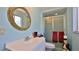 Charming bathroom with decorative mirror, a shower, and elegant fixtures, creating a relaxing atmosphere at 60 Palmetto Dr, Ormond Beach, FL 32176
