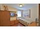 Guest bedroom with a twin bed, wood laminate floors, and ample closet space at 60 Palmetto Dr, Ormond Beach, FL 32176