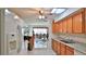 Bright kitchen with granite counters, stainless steel sink, and white tile flooring at 60 Palmetto Dr, Ormond Beach, FL 32176