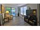 Inviting living room with laminate flooring, a beige recliner, and sliding glass door to screened patio at 60 Palmetto Dr, Ormond Beach, FL 32176