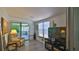 Living room with wood laminate floors, natural lighting, and access to the Florida room at 60 Palmetto Dr, Ormond Beach, FL 32176