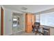 Bright home office with ample natural light, complemented by practical furniture and a view to the kitchen at 60 Palmetto Dr, Ormond Beach, FL 32176