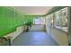 Bright sunroom with green blinds, ample windows, and a charming plant, perfect for enjoying natural light at 60 Palmetto Dr, Ormond Beach, FL 32176
