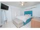 Bright bedroom with a plush upholstered headboard, bench, and neutral decor at 624 Cardinal St, Ocoee, FL 34761