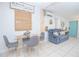 Cozy dining area with a glass-top table and comfortable seating, adjacent to the living room, perfect for Gathering meals at 624 Cardinal St, Ocoee, FL 34761