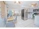 Open concept kitchen with stainless steel fridge and views of the living room at 624 Cardinal St, Ocoee, FL 34761