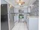 Well-lit kitchen with stainless steel appliances, gray cabinets, and attractive backsplash, offering a modern and functional space at 624 Cardinal St, Ocoee, FL 34761