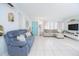 Bright living room with tile floors, comfortable seating, and a turquoise door adding a pop of color at 624 Cardinal St, Ocoee, FL 34761
