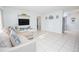 Bright and spacious living room featuring tile floors, a comfortable sofa, and modern decor, creating a welcoming ambiance at 624 Cardinal St, Ocoee, FL 34761