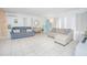 Bright living room featuring two sofas, tile floors, and a turquoise door, creating a welcoming atmosphere at 624 Cardinal St, Ocoee, FL 34761