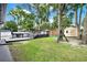 Backyard featuring pool, deck, mature trees, and storage shed at 679 N Endeavour Dr, Winter Springs, FL 32708