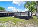 View of the backyard with a raised pool deck, screened lanai, and lush grass at 679 N Endeavour Dr, Winter Springs, FL 32708