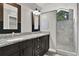 Bathroom features a double vanity with granite countertops and a tiled walk-in shower at 679 N Endeavour Dr, Winter Springs, FL 32708