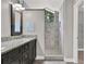 Updated bathroom featuring a double vanity, a stone shower, and modern fixtures at 679 N Endeavour Dr, Winter Springs, FL 32708