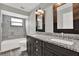 Updated bathroom features a double vanity with granite countertops and a tiled shower/tub at 679 N Endeavour Dr, Winter Springs, FL 32708