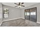 Bedroom with wood-look tile, neutral paint, and patio access at 679 N Endeavour Dr, Winter Springs, FL 32708