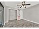 Spacious bedroom featuring a ceiling fan, wood-look flooring, and a walk-in closet at 679 N Endeavour Dr, Winter Springs, FL 32708