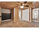 Bedroom featuring wood paneling, carpet, and built in closet at 679 N Endeavour Dr, Winter Springs, FL 32708