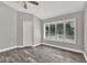 Bedroom with wood-look tile, neutral paint and many windows at 679 N Endeavour Dr, Winter Springs, FL 32708