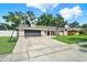 A single story home featuring a large front yard, basketball hoop and 2 car garage at 679 N Endeavour Dr, Winter Springs, FL 32708