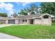 Attractive single-story home featuring a well-manicured lawn and mature trees at 679 N Endeavour Dr, Winter Springs, FL 32708