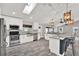 Bright, open kitchen features white cabinetry, stainless steel appliances, and a skylight at 679 N Endeavour Dr, Winter Springs, FL 32708