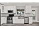 Modern kitchen features stainless steel appliances, granite countertops and white cabinets at 679 N Endeavour Dr, Winter Springs, FL 32708