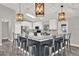 Stylish kitchen island featuring barstool seating, pendant lights and stainless steel appliances at 679 N Endeavour Dr, Winter Springs, FL 32708