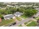 Aerial view of the home with mature trees, a manicured lawn, and neighborhood street at 7011 Archwood Dr, Orlando, FL 32819