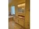 Bathroom showcases granite countertop, a tub, and a glass block window for natural light at 7011 Archwood Dr, Orlando, FL 32819