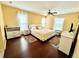 Bright bedroom features a ceiling fan, hardwood floors, and natural light from two windows at 7011 Archwood Dr, Orlando, FL 32819