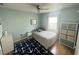 Bright bedroom with a ceiling fan and a window, with simple and efficient furniture at 7011 Archwood Dr, Orlando, FL 32819