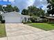Well maintained home with a pristine lawn, an attached two-car garage and a spacious driveway at 7011 Archwood Dr, Orlando, FL 32819