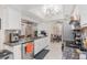 Open kitchen featuring granite countertops, bright white cabinets, and modern stainless steel appliances at 7011 Archwood Dr, Orlando, FL 32819